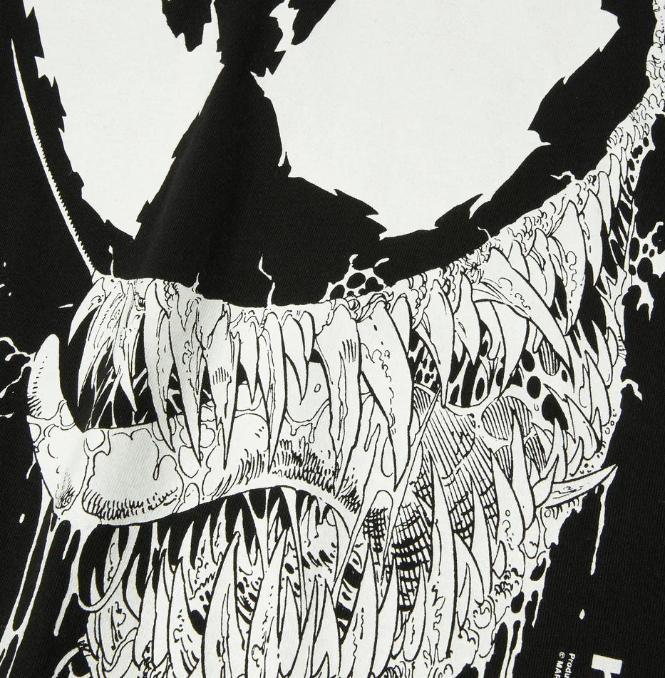 Black and white illustration of Venom's head with detailed patterns on a white background