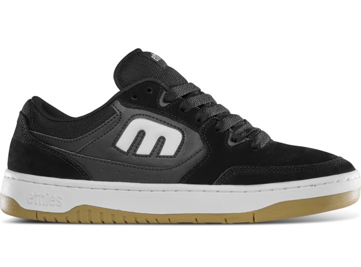 etnies Loot Shoe in black and white with suede upper, mid-puff silhouette, and retro-inspired court shoe design with skate-ready tech.