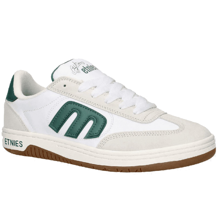 A white low-top sneaker by Ethnies, featuring a prominent green 'm' logo on the side, a green heel tab, and a brown gum sole.