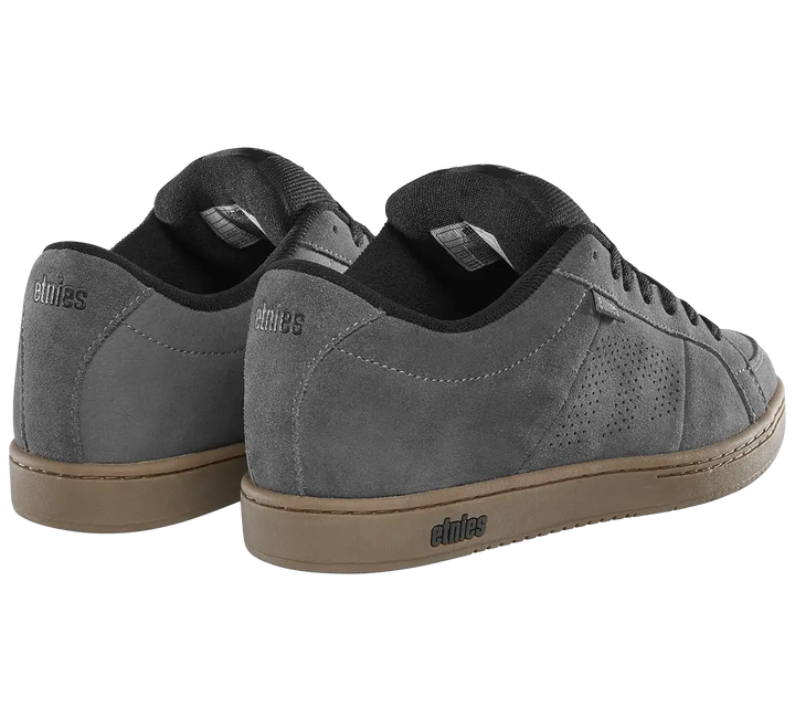 A pair of gray suede sneakers with black laces and a tan gum sole, shown from a three-quarters angle on a white background. The brand name 'elites' is visible on the heel and midsole.