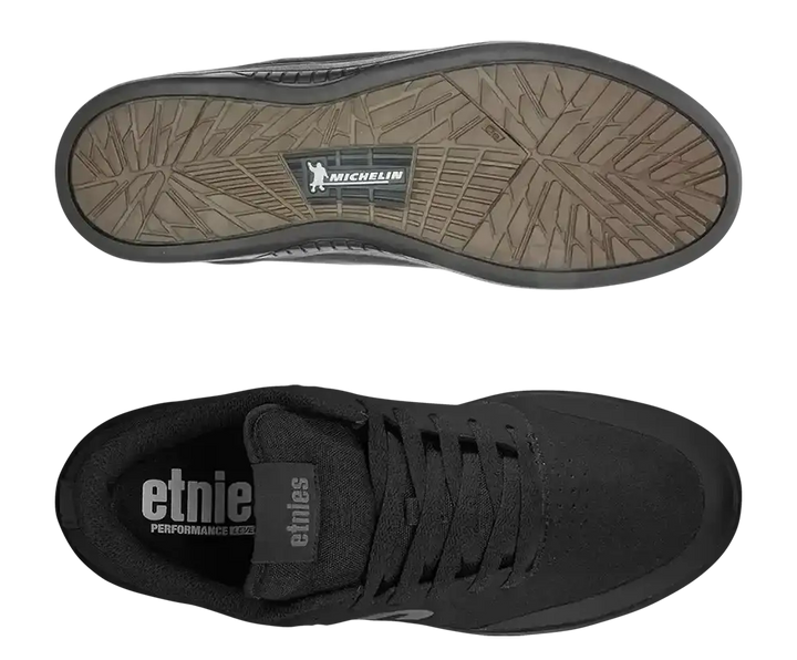 Black Etnie skate shoe shown from the top and bottom views, featuring a textured brownish-gray Michelin sole and a black interior with white Etnie branding.