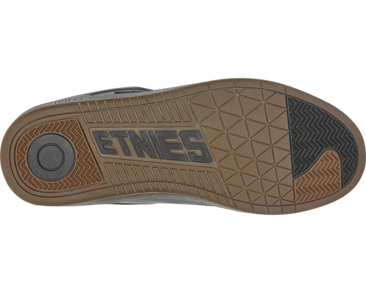 Close-up of a shoe sole with 'Etnies' branding on a white background