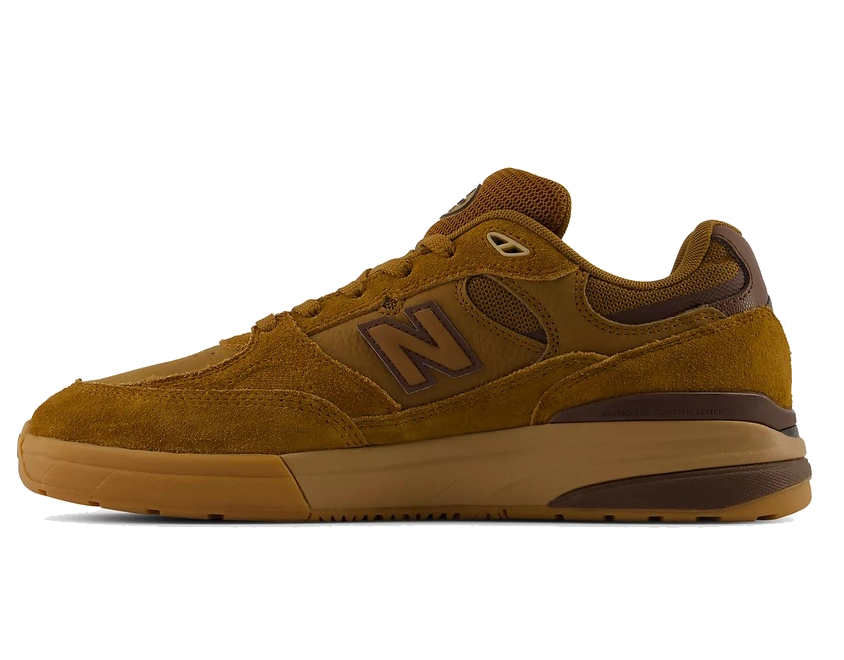 A single New Balance sneaker in a warm brown suede and mesh upper with a matching gum sole, shown in a side profile on a white background.
