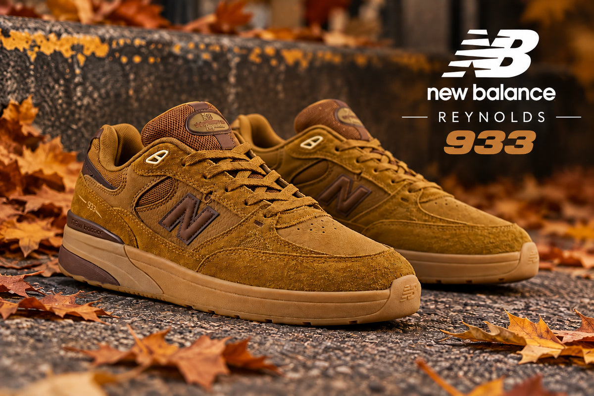 A pair of New Balance 933 sneakers in a warm brown and tan colorway, styled outdoors on a paved surface surrounded by fallen autumn leaves. The New Balance logo and 'Reynolds 933' text are displayed in the upper right corner.