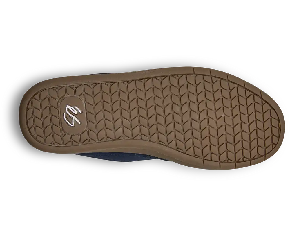 The outsole of a slip-on shoe, showing a brown textured tread pattern with a small white stylized logo in the heel area, photographed on a white background.