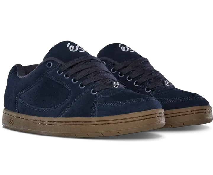 A pair of navy blue suede skate shoes with brown gum soles, shown from a three-quarters angle on a white background.