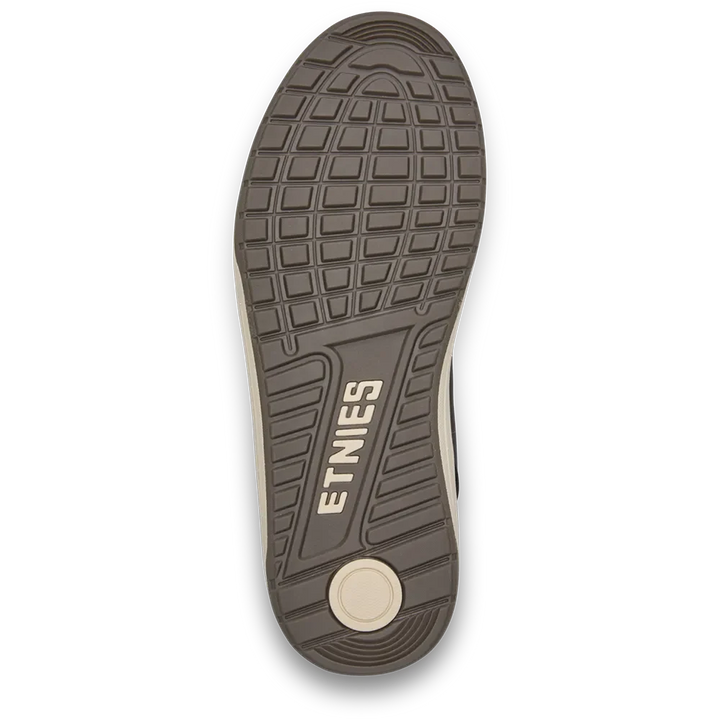 Top-down view of a shoe sole showing the textured tread pattern and the embossed brand name 'ETNIES' in beige on a dark brown rubber outsole, with a light beige footbed visible at the heel.