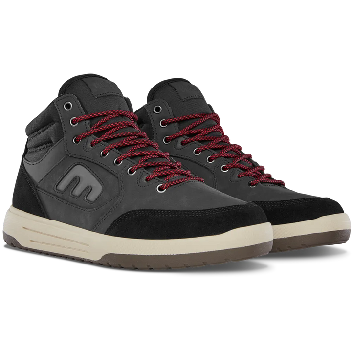 A pair of high-top sneakers in black suede and leather, featuring dark red braided laces, a cream midsole, and a brown outsole. The shoe on the left is angled to show the side profile, including a stylized 'm' logo on the side panel, while the shoe on the right is angled to show the front three-quarter view.