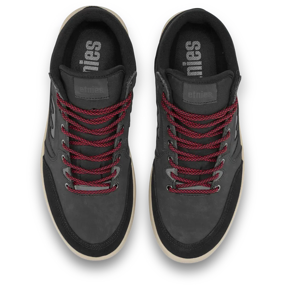A pair of low-top sneakers shown from a top-down view. The shoes are primarily black with dark red laces and a light beige outsole, featuring the brand name 'ethnies' on the tongue and insole.