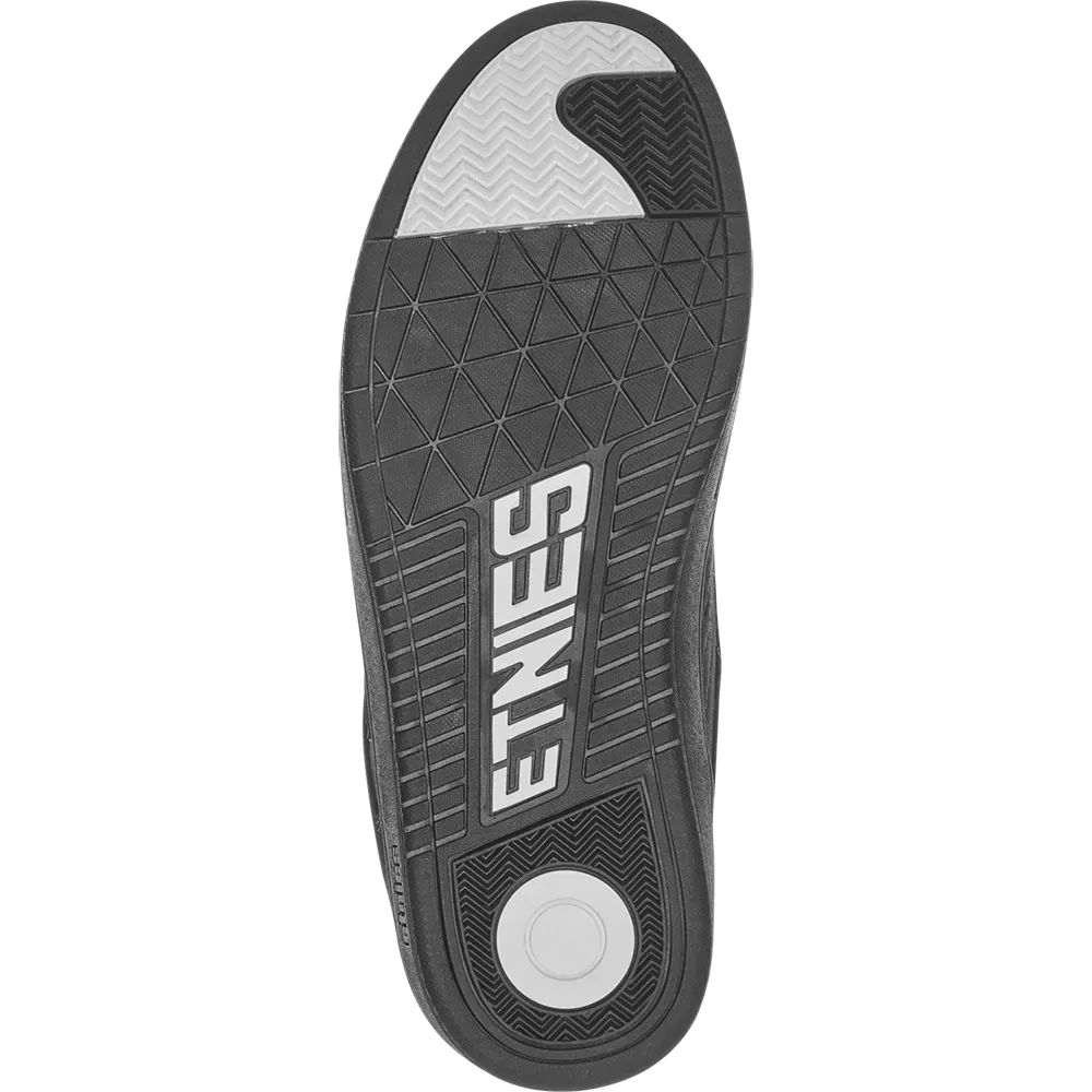 The black and gray outsole of a shoe, featuring the brand name 'ETNIES' in white on the heel, a circular white tread, and a textured gray toe section.