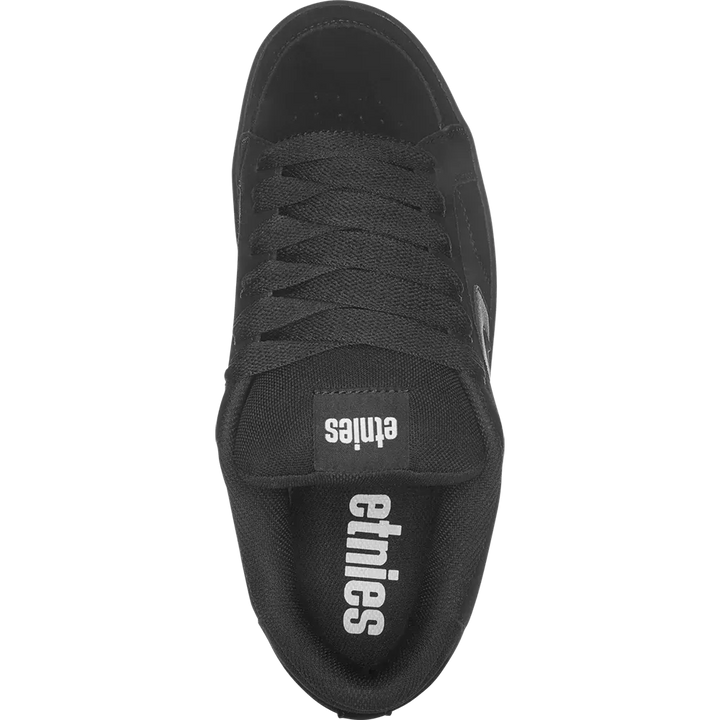 Black sneaker with 'etnies' branding on a white background