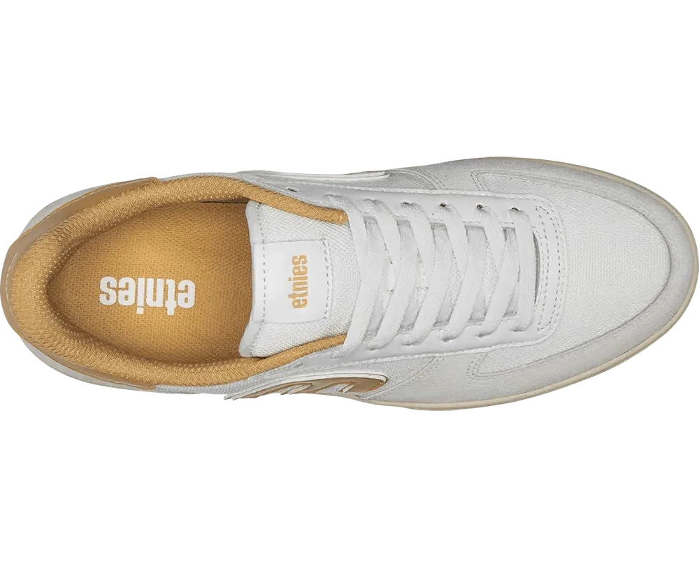 White sneaker with tan sole on a white background