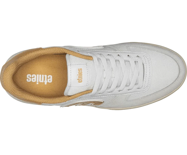White sneaker with tan sole on a white background