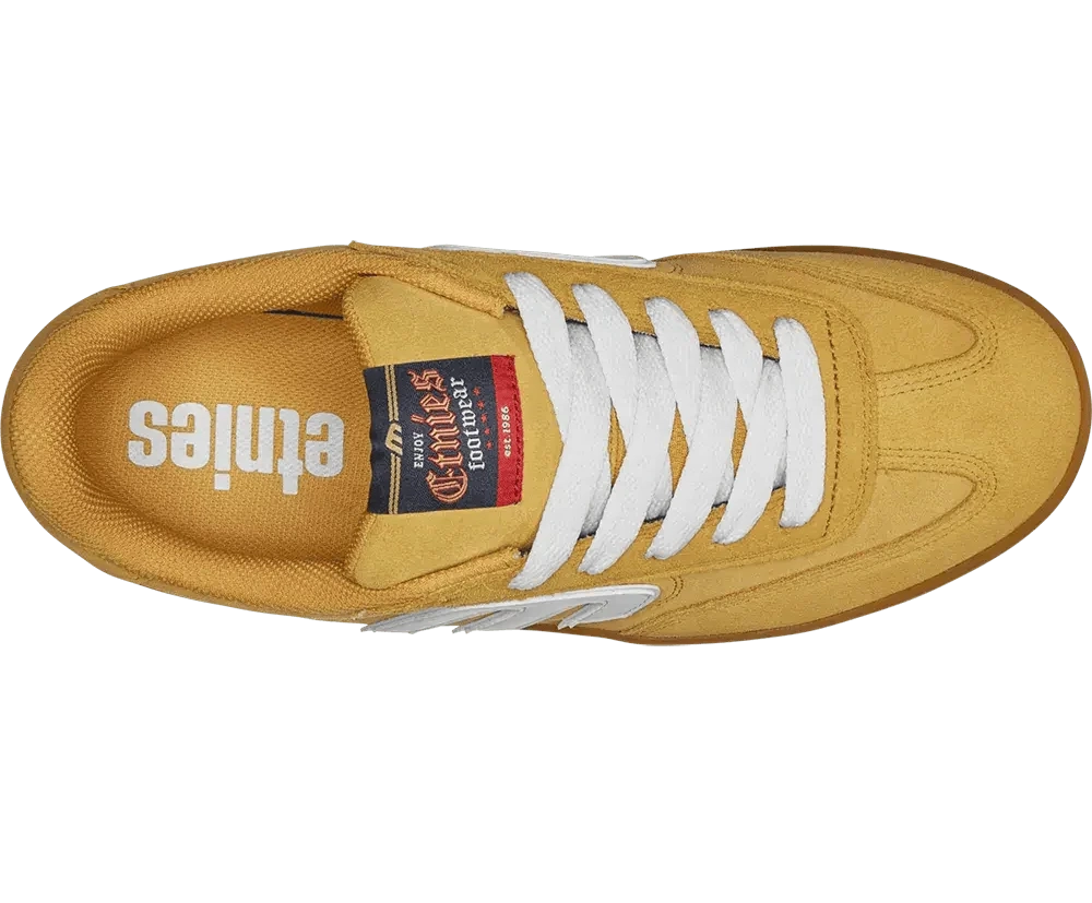 Yellow sneaker with white laces on a white background