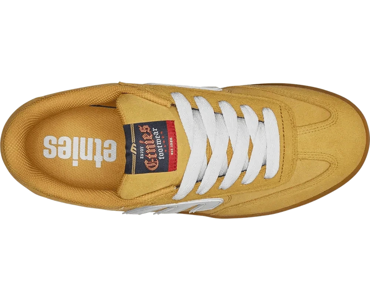 Yellow sneaker with white laces on a white background