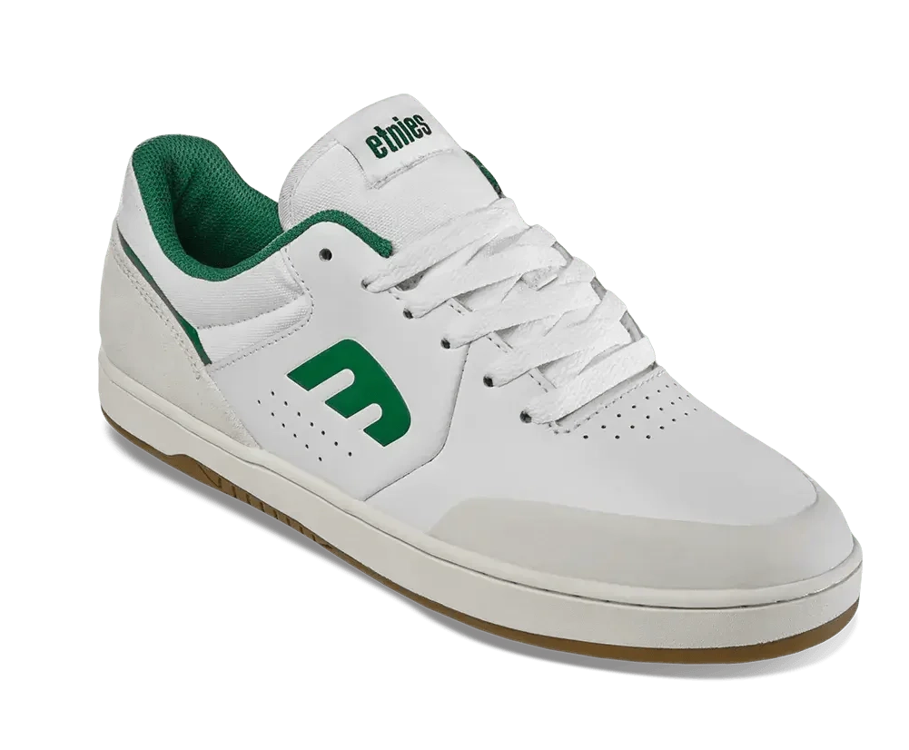 White sneaker with green accents on a white background