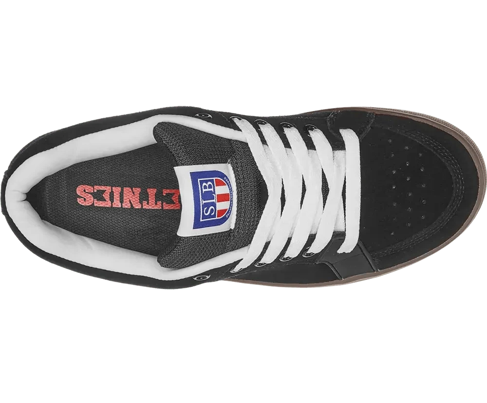 Black sneaker with white laces and visible brand logo on a white background