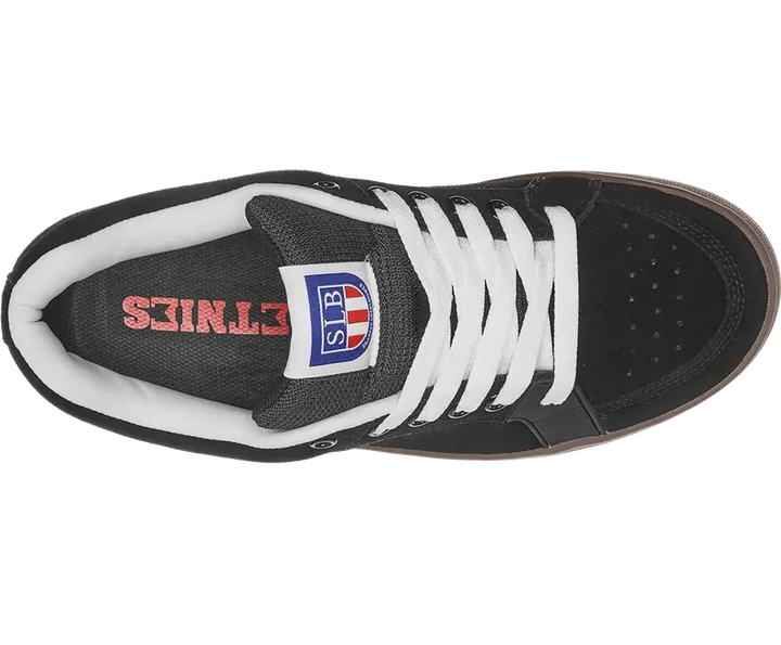 Black sneaker with white laces and visible brand logo on a white background