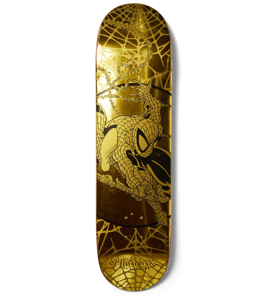 Skateboard deck with gold and black design on a white background