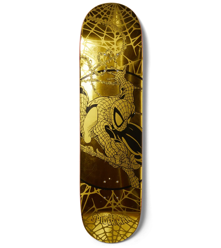 Skateboard deck with gold and black design on a white background