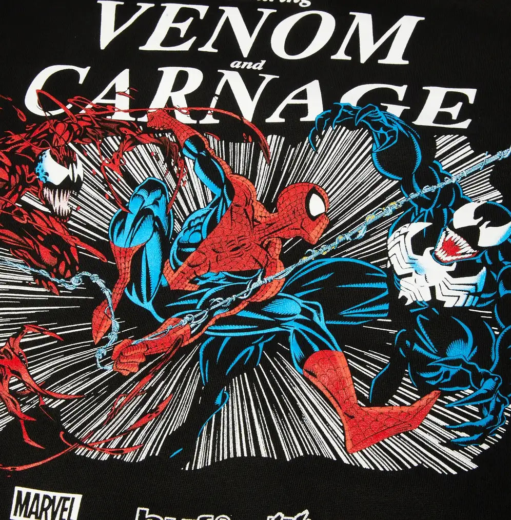 Close-up of a black Marvel graphic print featuring Spider-Man and Venom with the text 'Venom and Carnage' in large white letters.