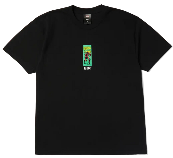 A black short-sleeve crewneck t-shirt featuring a small graphic print on the left chest. The graphic depicts a character in a red outfit against a green background with yellow text, and the word 'HUGO' printed in white below.