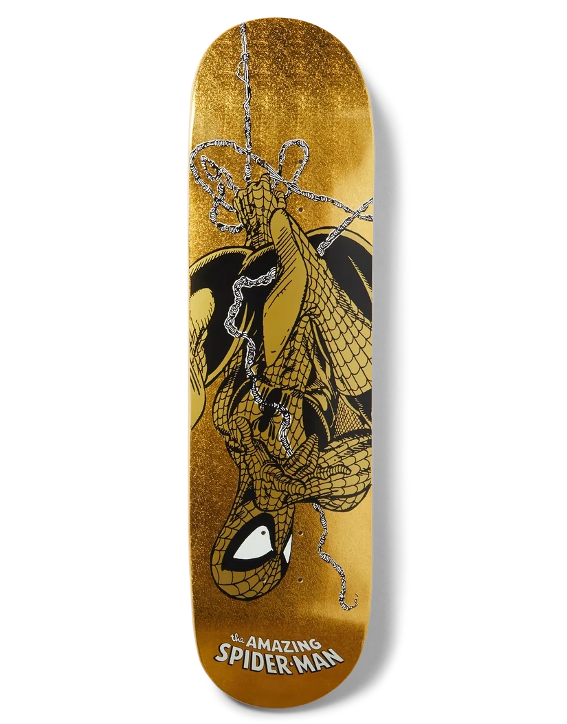 A skateboard deck featuring a gold glitter background with a graphic of Spider-Man hanging upside down in black and silver web lines, with 'The Amazing Spider-Man' text at the bottom.