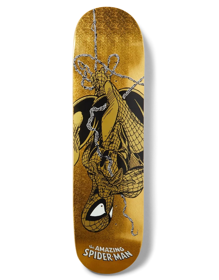A skateboard deck featuring a gold glitter background with a graphic of Spider-Man hanging upside down in black and silver web lines, with 'The Amazing Spider-Man' text at the bottom.