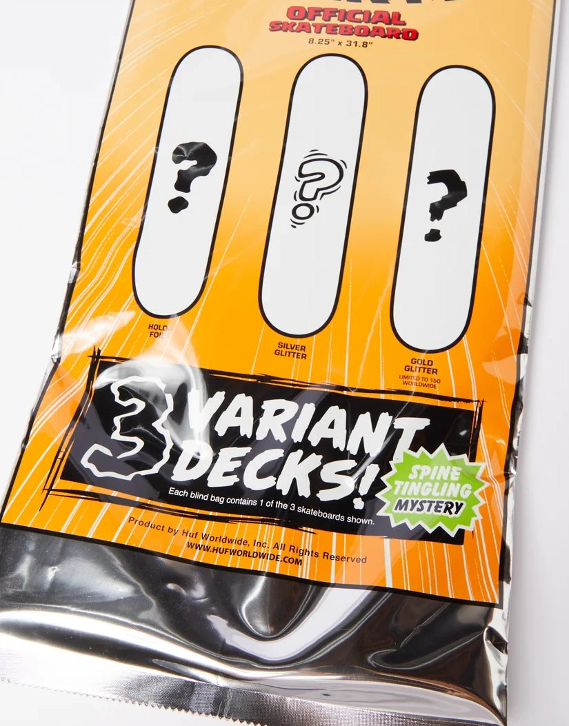 A sealed retail package for a skateboard mystery bag. The front card is bright orange with three white slots showing question marks, large text reading '3 VARIANT DECKS!', and a green 'Spine Tying Mystery' badge.