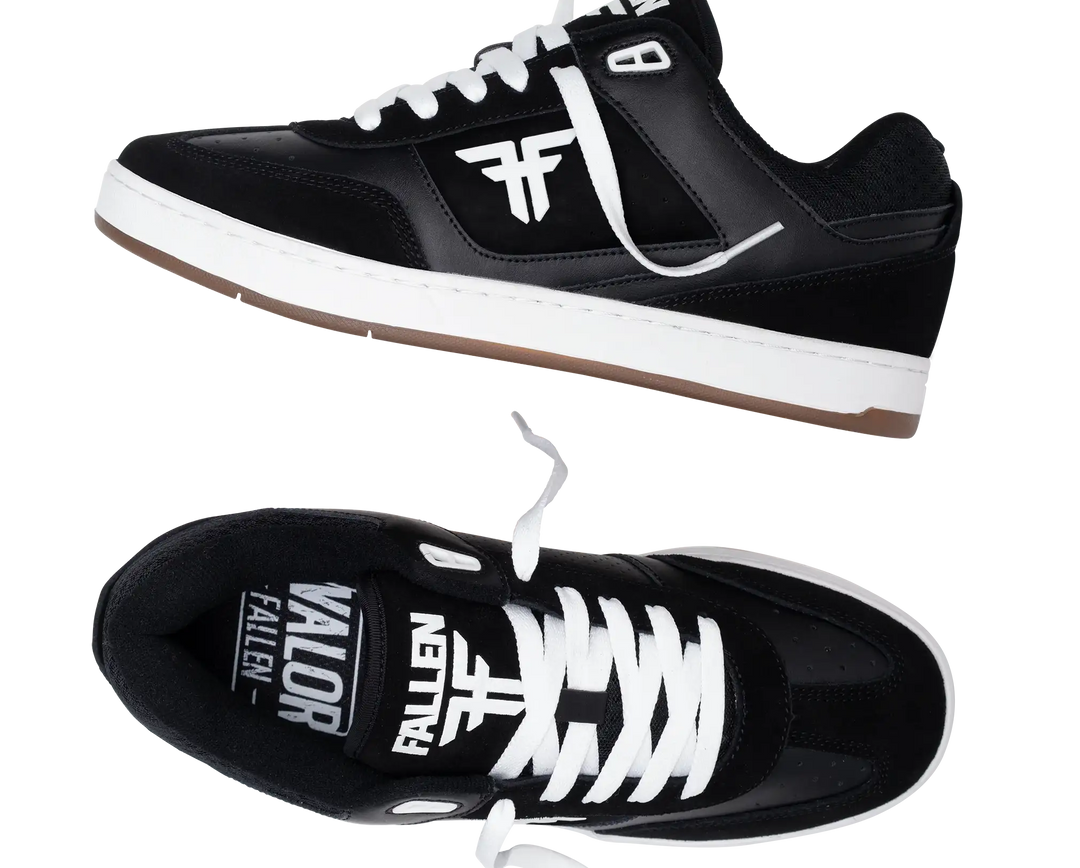 Black sneakers with white laces and visible branding on a white background