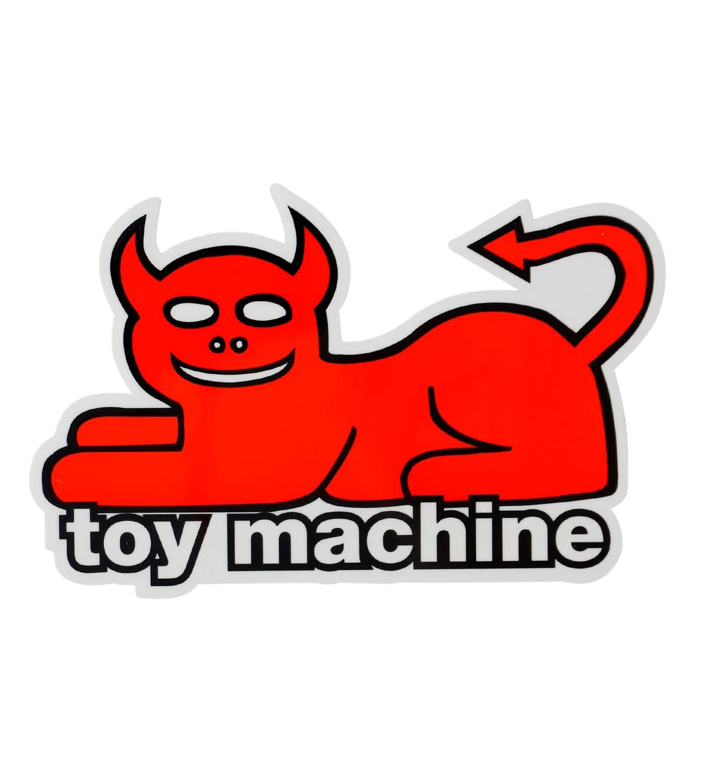 A red cartoon devil-like cat or demon lying down with horns, a curved tail, and the words 'toy machine' in white outlined text across the bottom, shown on a plain white background.