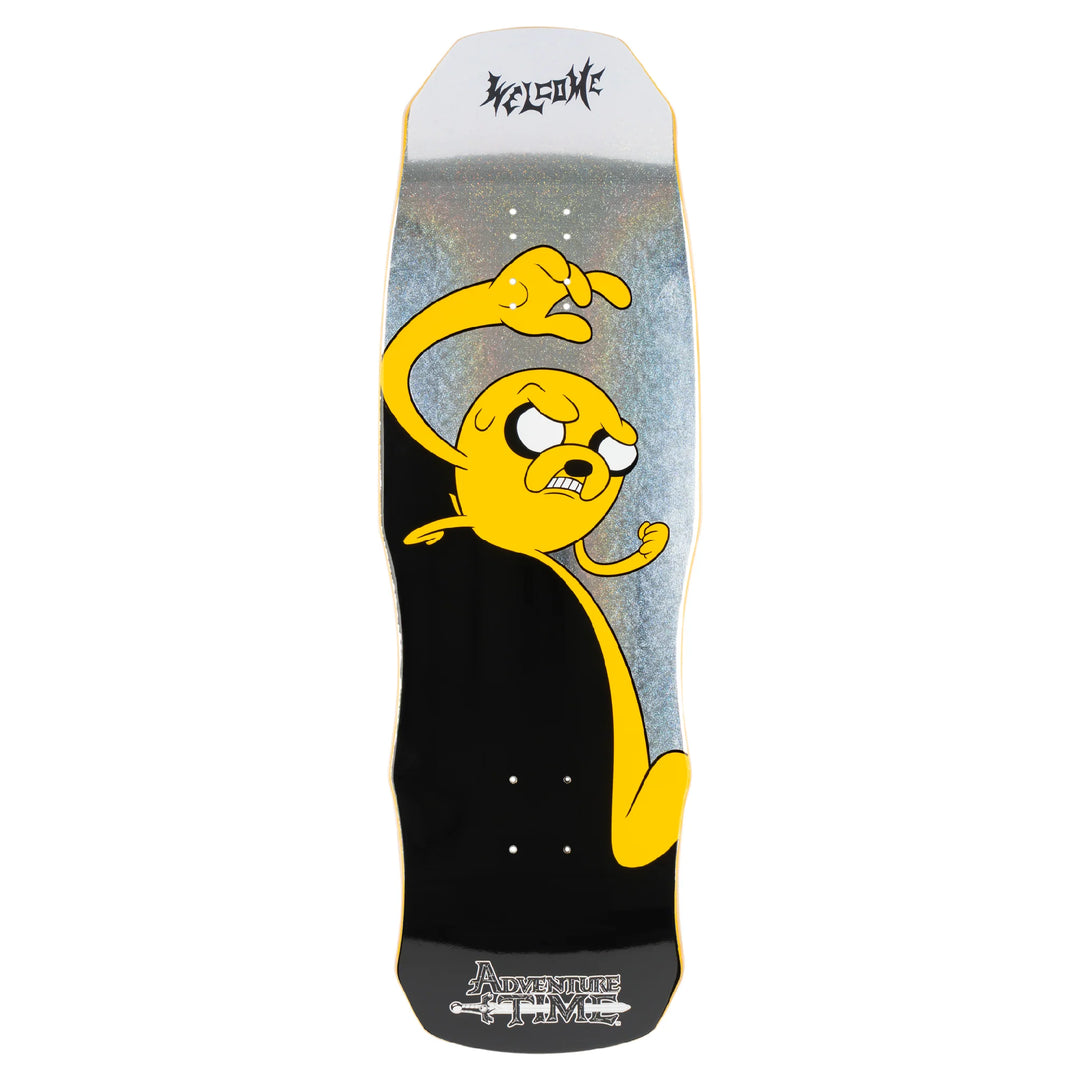 Welcome x Adventure Time Jake graphic on 9.75 Dark Lord deck with prism foil details and black background.