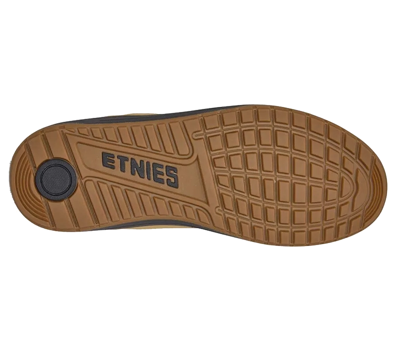 The brown rubber outsole of a shoe, featuring the embossed brand name 'ETNIES' and a textured grid pattern, shown against a plain white background.