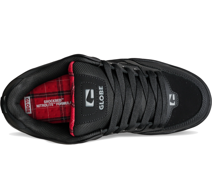 A black low-top sneaker shown from a side profile view on a white background, featuring a red and black plaid interior lining with 'GLOBE' branding.