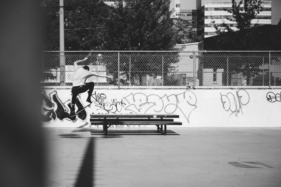 skateboarder doing ollie onto picnic table