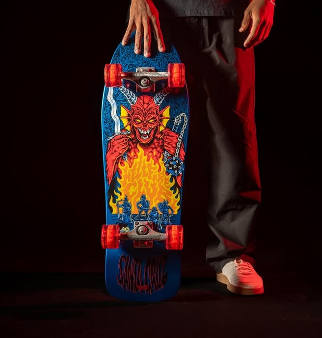 skater holding a santa cruz x stranger things skateboard against a black background