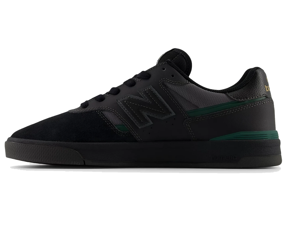 Black sneaker with green accents on a white background