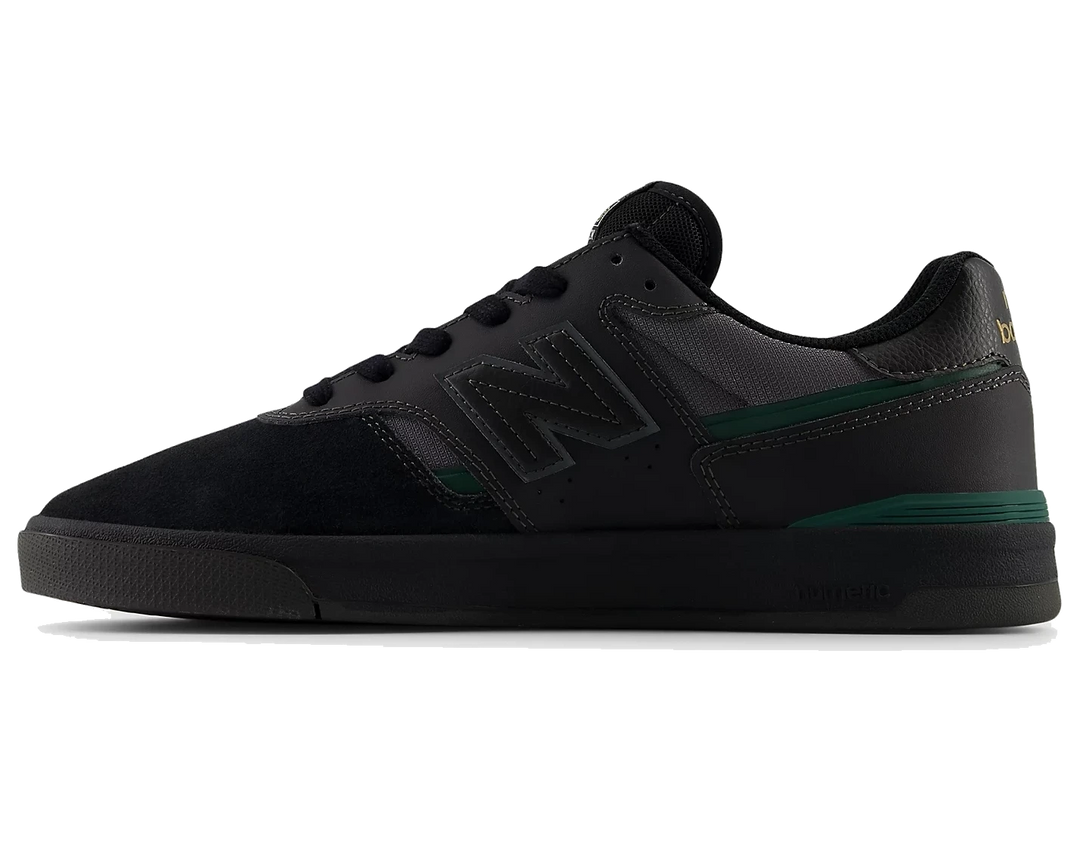 Black sneaker with green accents on a white background