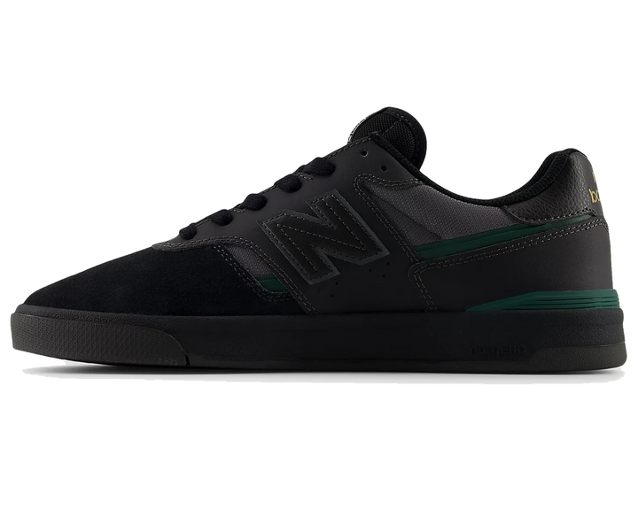 Black sneaker with green accents on a white background