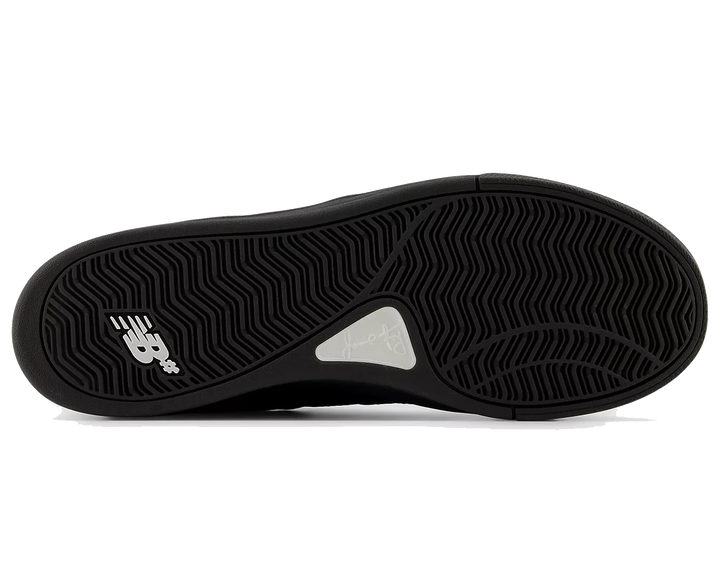Black sneaker sole with New Balance logo on a white background