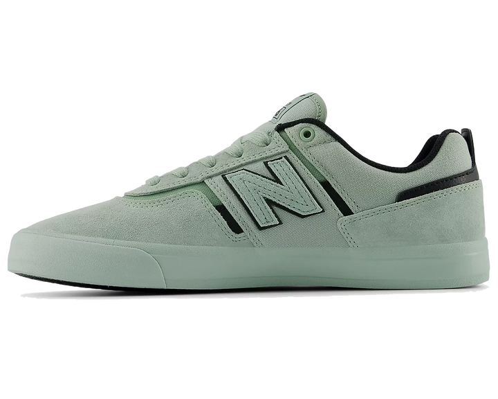 Light green sneaker with New Balance logo on a white background