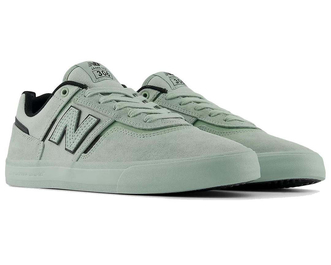 Pair of light green sneakers with New Balance logo on a white background