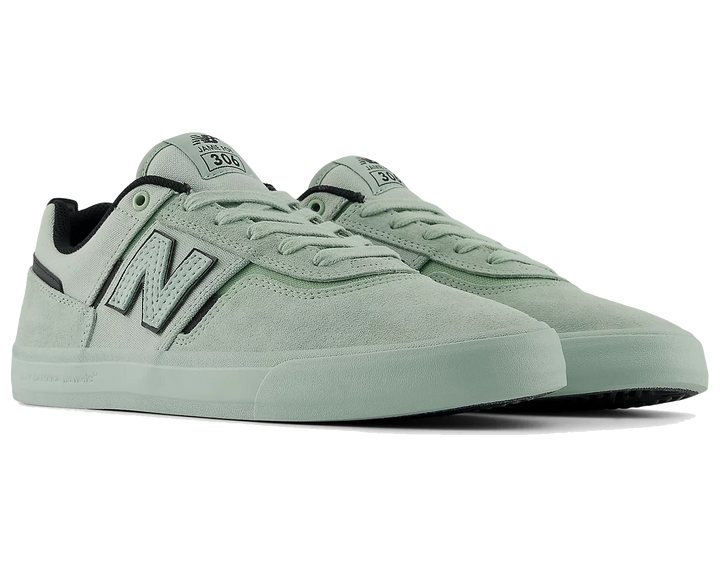 Pair of light green sneakers with New Balance logo on a white background