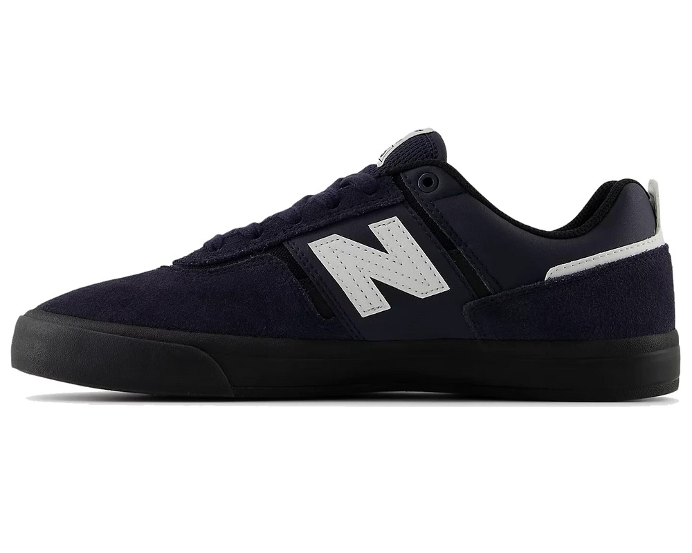 Navy blue sneaker with a white logo on a white background