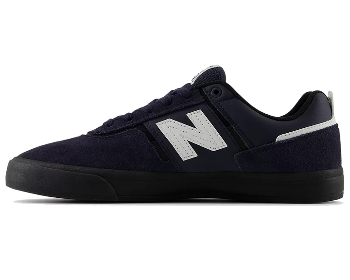 Navy blue sneaker with a white logo on a white background