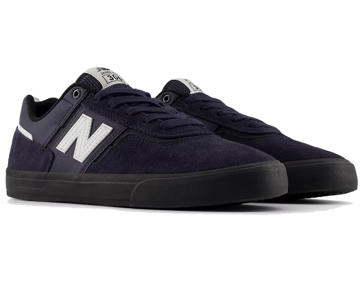 Pair of navy blue sneakers with white logo on a white background