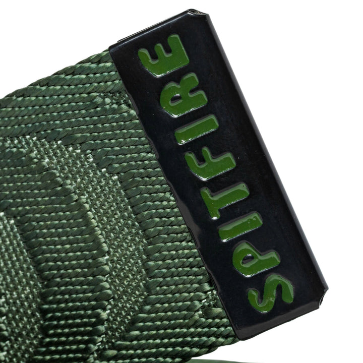 Close-up of a green woven strap with a black rectangular buckle or end tab featuring the word "SPIRE" in raised green letters, on a white background.