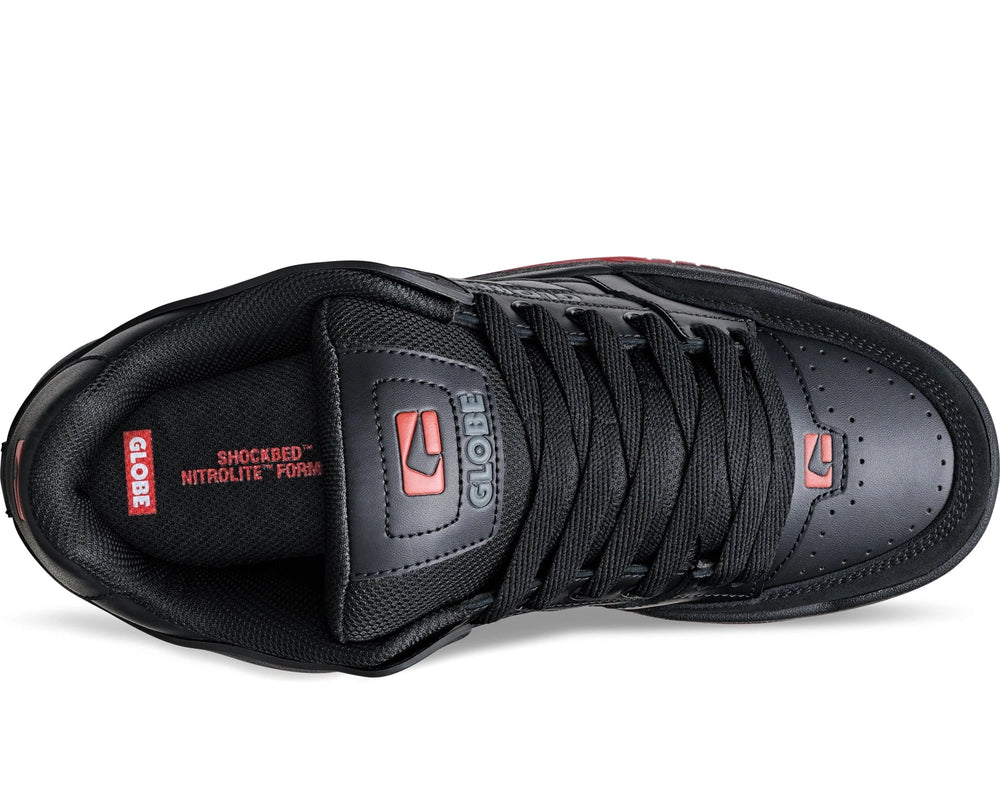 Black sneaker with red accents on a white background