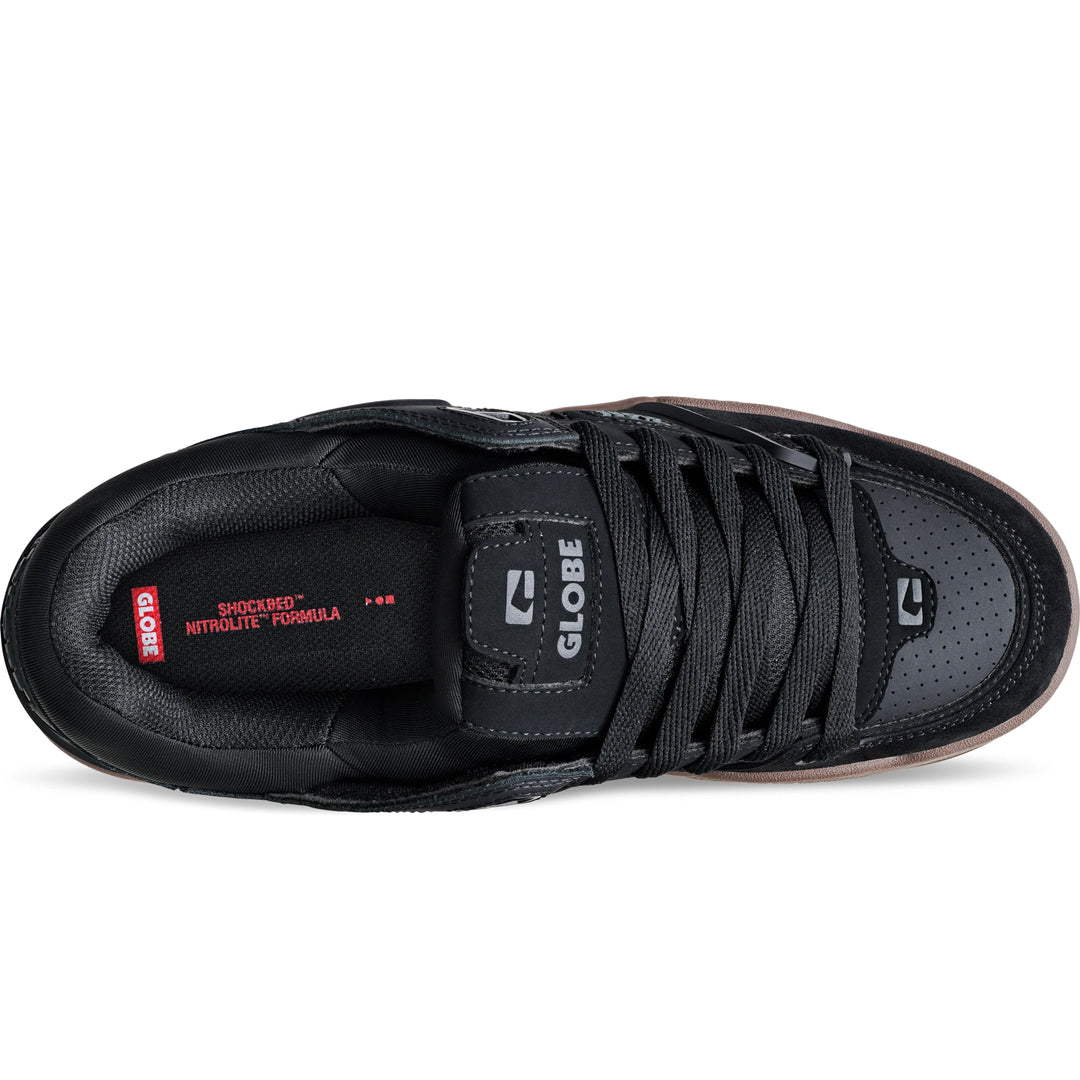 Black sneaker with visible branding on a white background