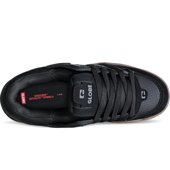 Black sneaker with visible branding on a white background